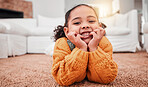 Child, relax and girl kid lying on the floor in a home lounge or living room resting with a smile, happy and excited. Cute, adorable and portrait of a young little female feeling happiness