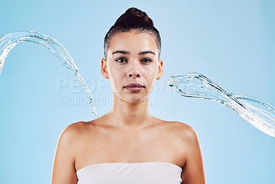 Buy stock photo Portrait, skincare and woman with water, beauty and grooming against a blue studio background. Face cleaning, female and person with clear liquid, aqua and cosmetics for morning routine and hygiene