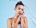 Portrait, cleaning and woman with water, skincare and luxury treatment against blue studio background. Face, female or person with clear liquid, aqua and dermatology for beauty, mockup and aesthetics