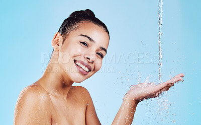 Buy stock photo Water drops, skincare and portrait of woman with smile for health, wellness and hygiene with cleaning routine. Shower, cosmetic beauty and happy girl in skin care for hands on blue studio background.