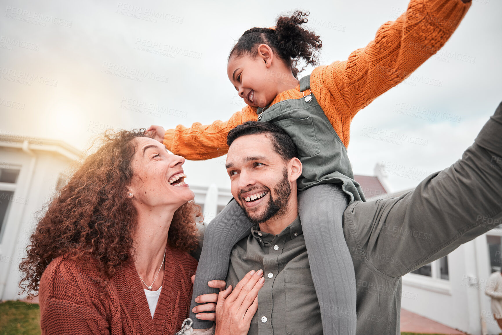 Buy stock photo Happy family, piggy back and parents with child in yard of new house, happiness and security at home. Interracial mother, father and girl bonding in backyard together with love and smile on weekend.