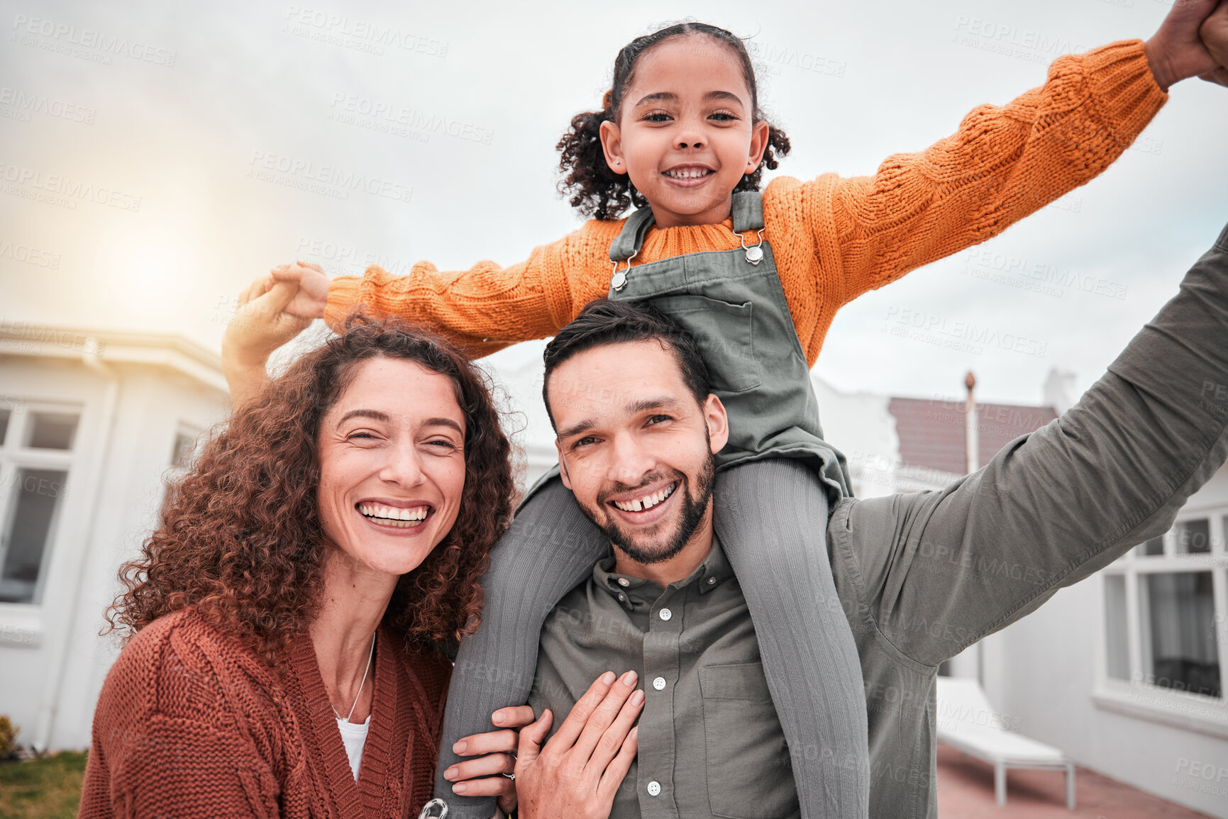 Buy stock photo Family portrait, piggy back and happy man, woman and child in yard of new house, happiness and security at home. Interracial mother, father and girl bonding in backyard together with love and smile.