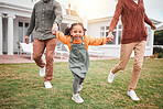 Child, new home and parents playing with kid outside a house bonding together on the lawn or grass feeling excited. Swinging, mother and father with little girl or portrait of daughter having fun