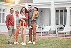Family, generations and happiness in portrait at holiday home, grandparents and parents with children on lawn. Men, women and kids, love and care in relationship and happy people smile on vacation