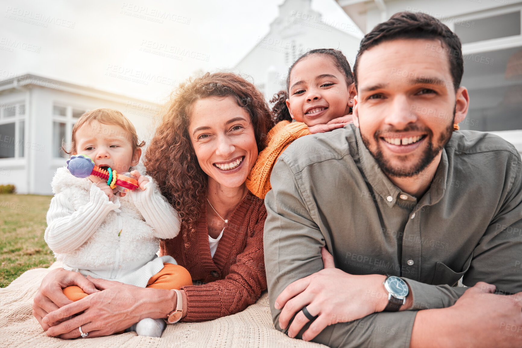 Buy stock photo Relax, picnic and portrait of a happy family bonding outside a house feeling excited and happiness. Smile, interracial and mother with children, kids and father with care together on vacation