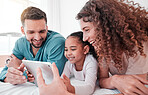 Happy, bed and family with a tablet, comic and connection for social media, funny videos or quality time. Parents, mother and father with daughter, bedroom and female child with device or interracial