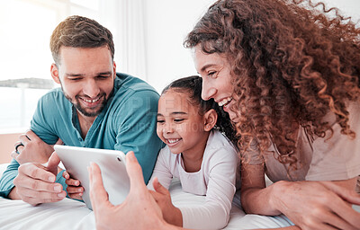 Buy stock photo Happy, bed and family with a tablet, comic and connection for social media, funny videos or quality time. Parents, mother and father with daughter, bedroom and female child with device or interracial