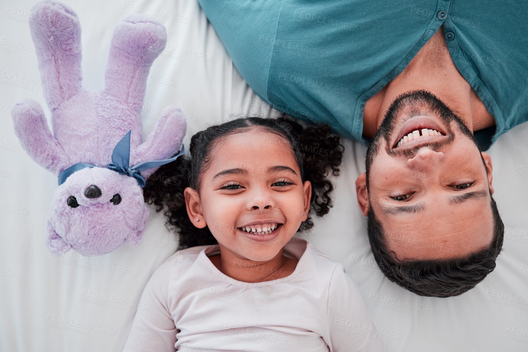 Buy stock photo Portrait of dad, child and teddy bear on bed from above, bonding and love with play time to relax. Smile, happiness and man with kid together in bedroom of family home in morning or bedtime in Mexico