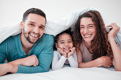 Buy stock photo Family in bed, happy parents and child in portrait, relax and smile together with love and care. Spending quality time under blanket, bonding and relationship, man and woman with young girl at home