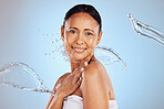 Old woman, water splash and beauty in portrait, hygiene and sustainable skincare for antiaging on blue background. Shower, clean and female smile, eco friendly dermatology and cosmetic care in studio