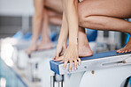 Swimmer, athlete feet and diving board of a swimming pool ready to start sport race for training. Fitness, water workout and swim sports at a wellness and exercise gym at a competition with dive