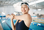 Professional swimming, happy woman and arm stretch with goggles at pool for training and power exercise. Water sports, champion athlete workout, asian swimmer at competition with smile and happiness.