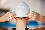 Sports, swimming pool or back of woman with cap ready for a race competition, exercise or training. Athlete swimmer, hands or closeup blur of girl starting workout for fitness, wellness or cardio 