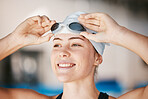 Professional swimming, face of happy woman with goggles at pool for training exercise and wellness with confidence. Water sports, workout and champion swimmer at competition with smile and happiness.