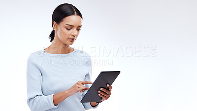 Buy stock photo Woman, tablet and reading in studio by white background for planning, schedule and search on web app. Girl, student and typing on mobile touchscreen for research, calendar or studying by mockup space