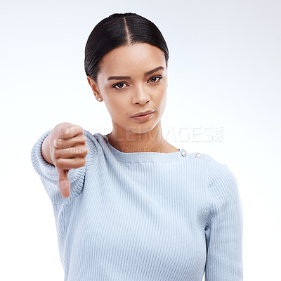 Buy stock photo Thumbs down, woman and portrait with problem and no opinion and choice in studio. Isolated, white background and bad review of young female feeling disappointed from vote and emoji of fail hand sign 