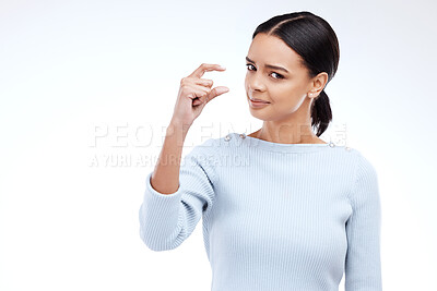 Buy stock photo Woman portrait, hand and small sign in studio with size, gesture or symbol on white background. Little, icon and finger emoji by face of girl on mockup with scale, review or opinion while isolated