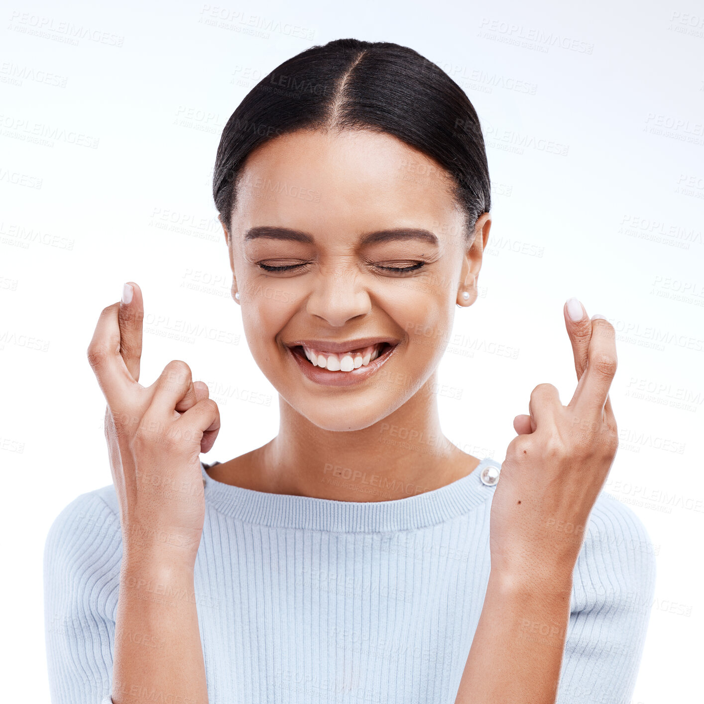 Buy stock photo Fingers crossed, hope and woman with a smile and happiness in a studio with wish. Excited, waiting and hands optimism emoji of a young female ready for winning and lottery prize with white background