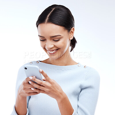 Buy stock photo Phone, typing and happy woman isolated on a white background for social media, funny meme or internet chat. Young person networking, communication or reading news or post on mobile app in studio
