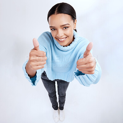 Buy stock photo Thumbs up, portrait and top view of happy woman in white background, winner and isolated studio. Female model, thumb and smile to celebrate winning achievement, like emoji and yes feedback of support