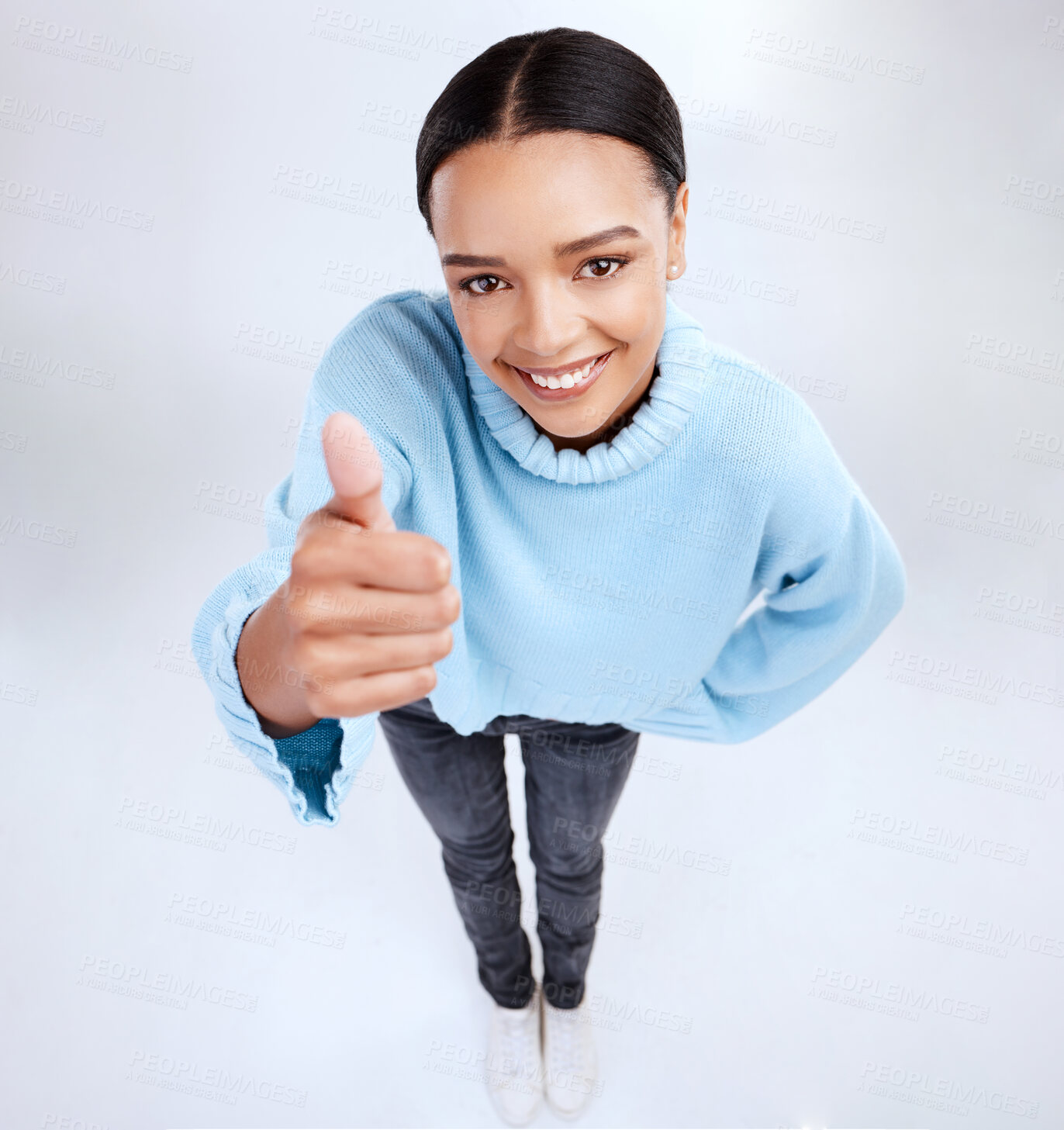 Buy stock photo Portrait, thumbs up and above with a woman on a white background in studio for motivation or success. Winner, emoji and hand gesture with an attractive young female saying thank you to show support