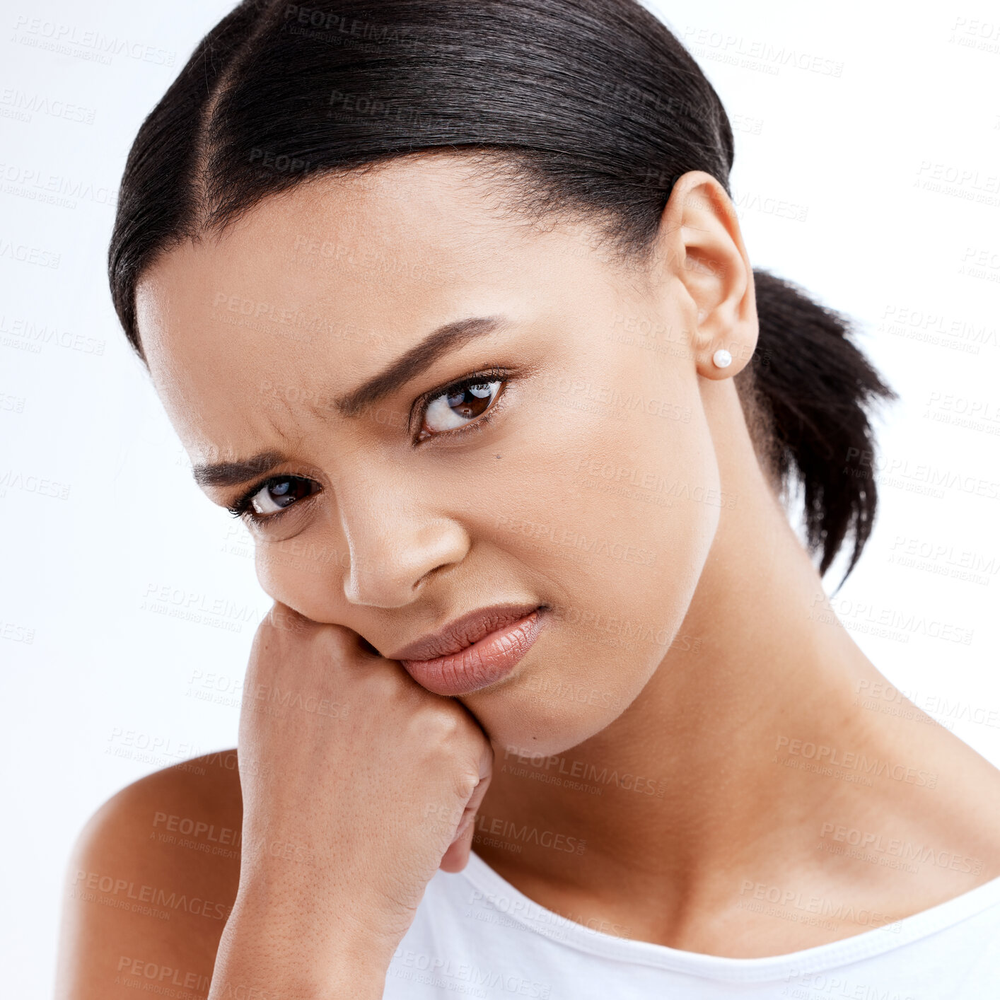 Buy stock photo Portrait, unhappy and frustrated with a woman in studio isolated on a white background looking moody. Face, frown and negative with a young woman looking confused, angry or bored while alone indoor