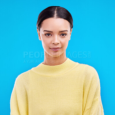 Buy stock photo Portrait, serious and woman in studio, relaxed and confident against a blue background. Face, pose and young female smile, relax and standing on isolated space, mockup and indoor product placement 