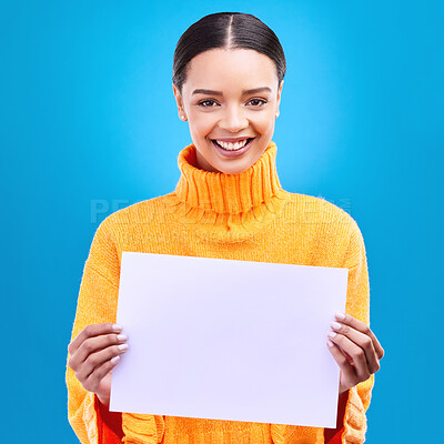 Buy stock photo Happy, mockup and paper with portrait of woman in studio for idea, branding and announcement. Promotion, space and smile with female and sign on blue background for news, logo and advertising