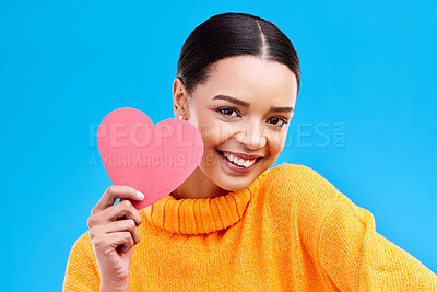 Buy stock photo Paper heart, happy woman and portrait on blue background, studio and backdrop. Female model, smile and shape of love, trust and support of peace, thank you and kindness on valentines day for romance