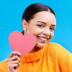 Paper heart, love and portrait of happy woman in studio, blue background and romantic sign. Female model, emoji shape and smile for care, support and thank you for kindness, valentines day or emotion
