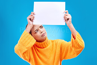 Buy stock photo Paper, banner and confused woman in studio on blue background with space, mockup and poster. Billboard, poster and unsure girl showing blank copy space, branding or isolated logo announcement 