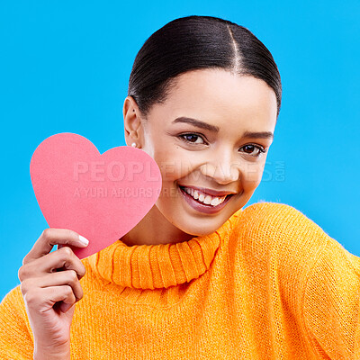 Buy stock photo Paper heart, smile and portrait of woman in studio, blue background and backdrop. Happy female model, love shape and care of trust, support and thank you for kindness, valentines day and emoji icon