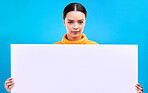 Studio, blank sign and portrait of woman with info and mockup isolated on blue background. Marketing, advertising and gen z girl with poster for product placement or news announcement mock up space.