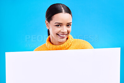 Buy stock photo Happy, mockup and poster with portrait of woman in studio for idea, branding and announcement. Promotion, space and smile with female and sign on blue background for news, logo and advertising