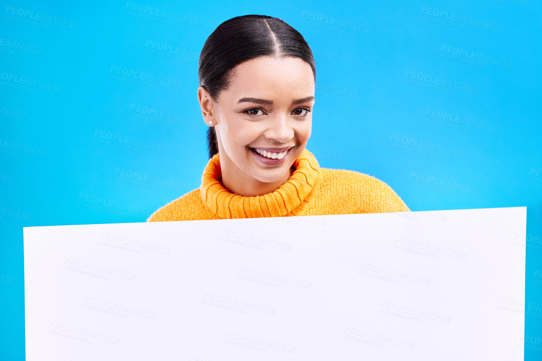 Buy stock photo Happy, mockup and poster with portrait of woman in studio for idea, branding and announcement. Promotion, space and smile with female and sign on blue background for news, logo and advertising