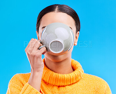 Buy stock photo Coffee drinking, woman and studio with morning latte, mug and hot beverage. Isolated, blue background and female model or young person with casual fashion and ceramic cup for tea drink or cappuccino