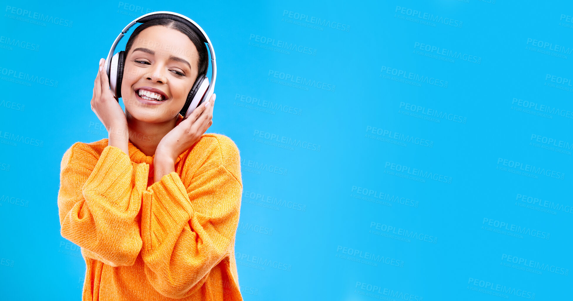 Buy stock photo Music headphones, woman and smile on blue background, mockup studio and backdrop. Happy female, gen z model and listening to sound, streaming album and audio connection on media, mock up and podcast