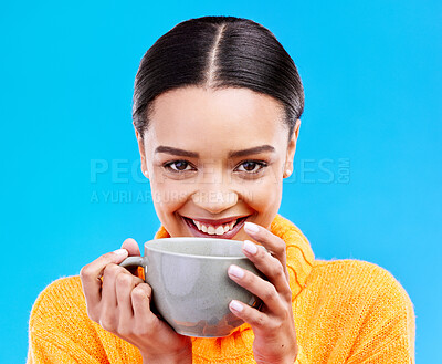 Buy stock photo Coffee, woman portrait and smile in studio with happiness and mug. Isolated, blue background and happy female model or young person with casual winter fashion, latte or tea drink with smiling joy