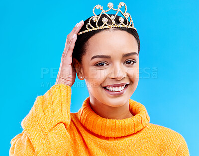Buy stock photo Pride, crown and portrait of woman in studio for celebration, princess and party. Smile, beauty and fashion with female and tiara on blue background excited for achievement, winner and prom event