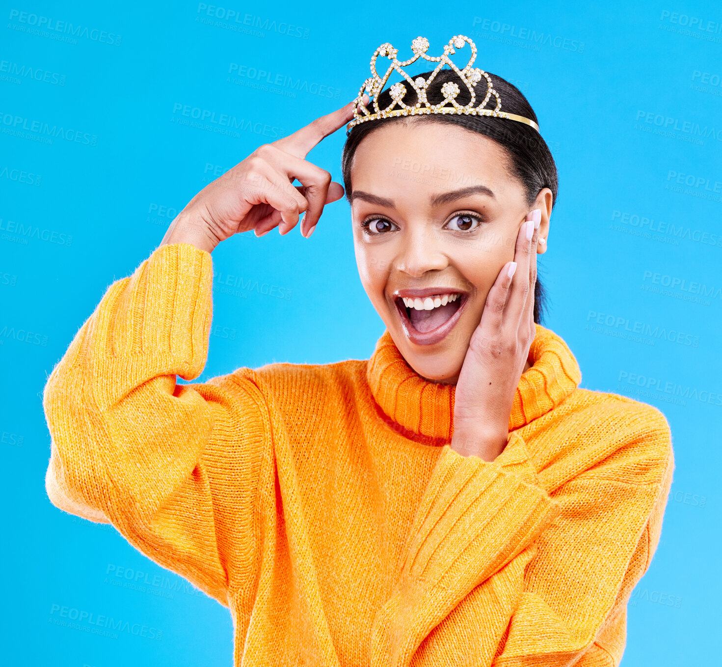 Buy stock photo Pointing, crown and portrait of woman in studio for celebration, princess or wow party. Smile, beauty or fashion with female tiara on blue background excited for achievement, winner and prom surprise