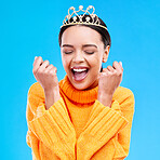 Winner, crown and portrait of woman in studio for celebration, princess and party. Smile, beauty and fashion with female and tiara on blue background excited for achievement, success and prom event