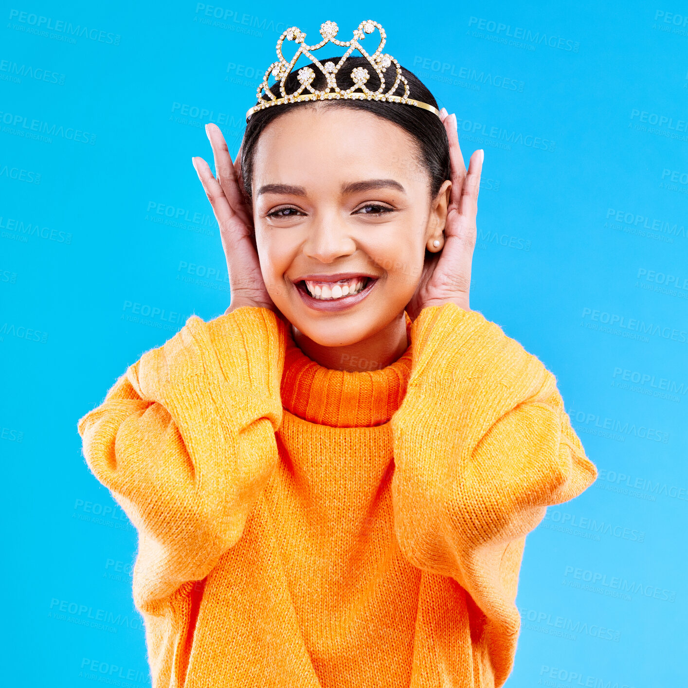 Buy stock photo Excited, crown and portrait of woman in studio for celebration, princess and party. Smile, beauty and fashion with female and tiara on blue background for achievement, winner and prom event