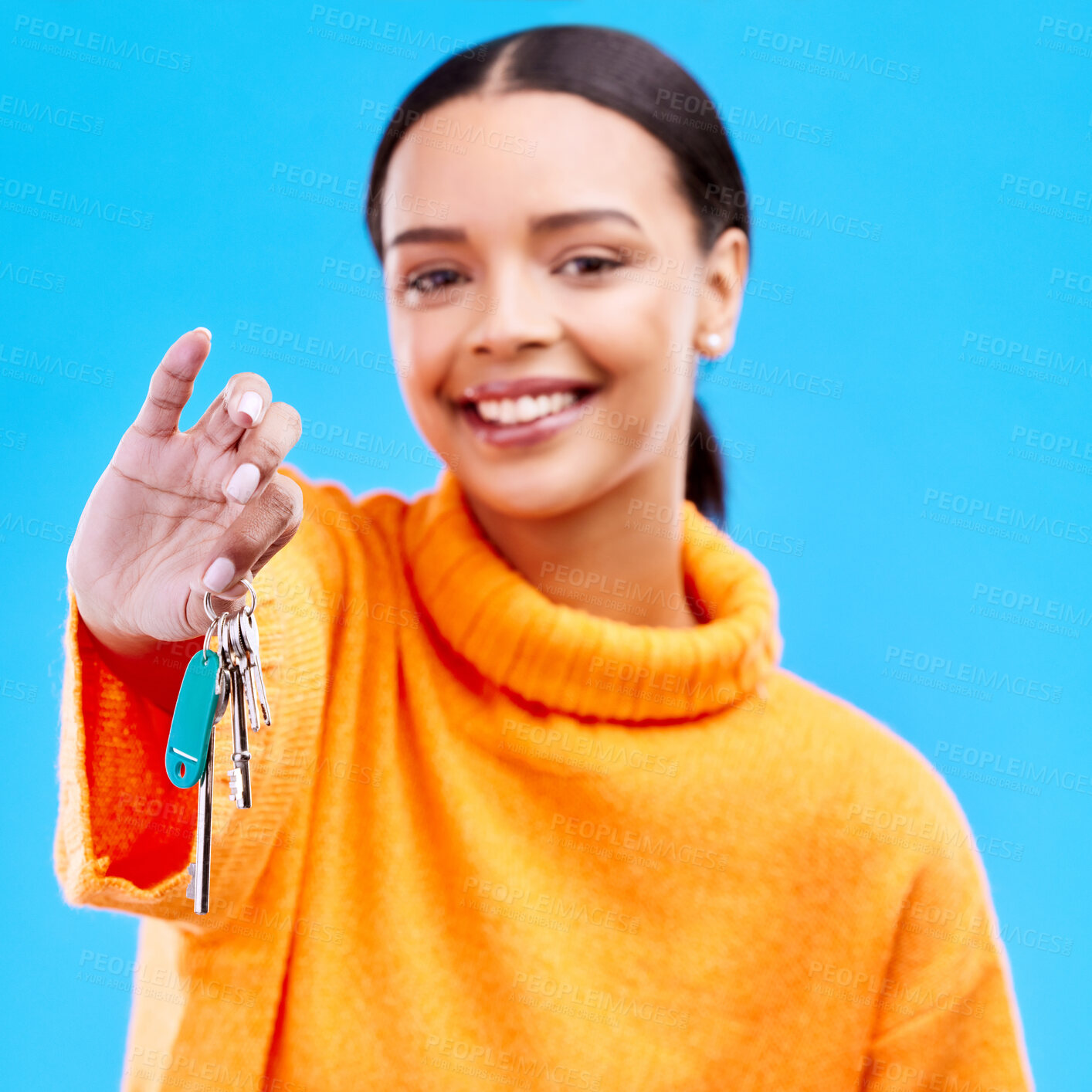 Buy stock photo House keys, happy and portrait of a woman in a studio with a property, real estate or apartment. Happiness, smile and face of female model homeowner with proud and positive mindset by blue background