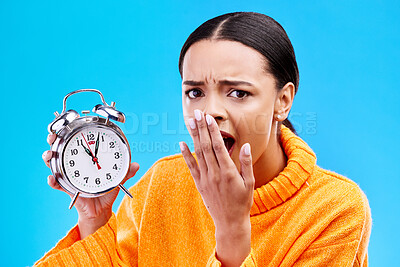 Buy stock photo Portrait, surprise and woman with an alarm clock, late and deadline with girl against a blue studio background. Face, female model and person with time, shocked and stress with schedule and wow