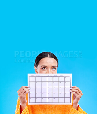 Buy stock photo Calendar, thinking and woman on blue background with paper for schedule, planning and agenda in studio. Time management, strategy and eyes of girl with month poster for date, weekly planner and event