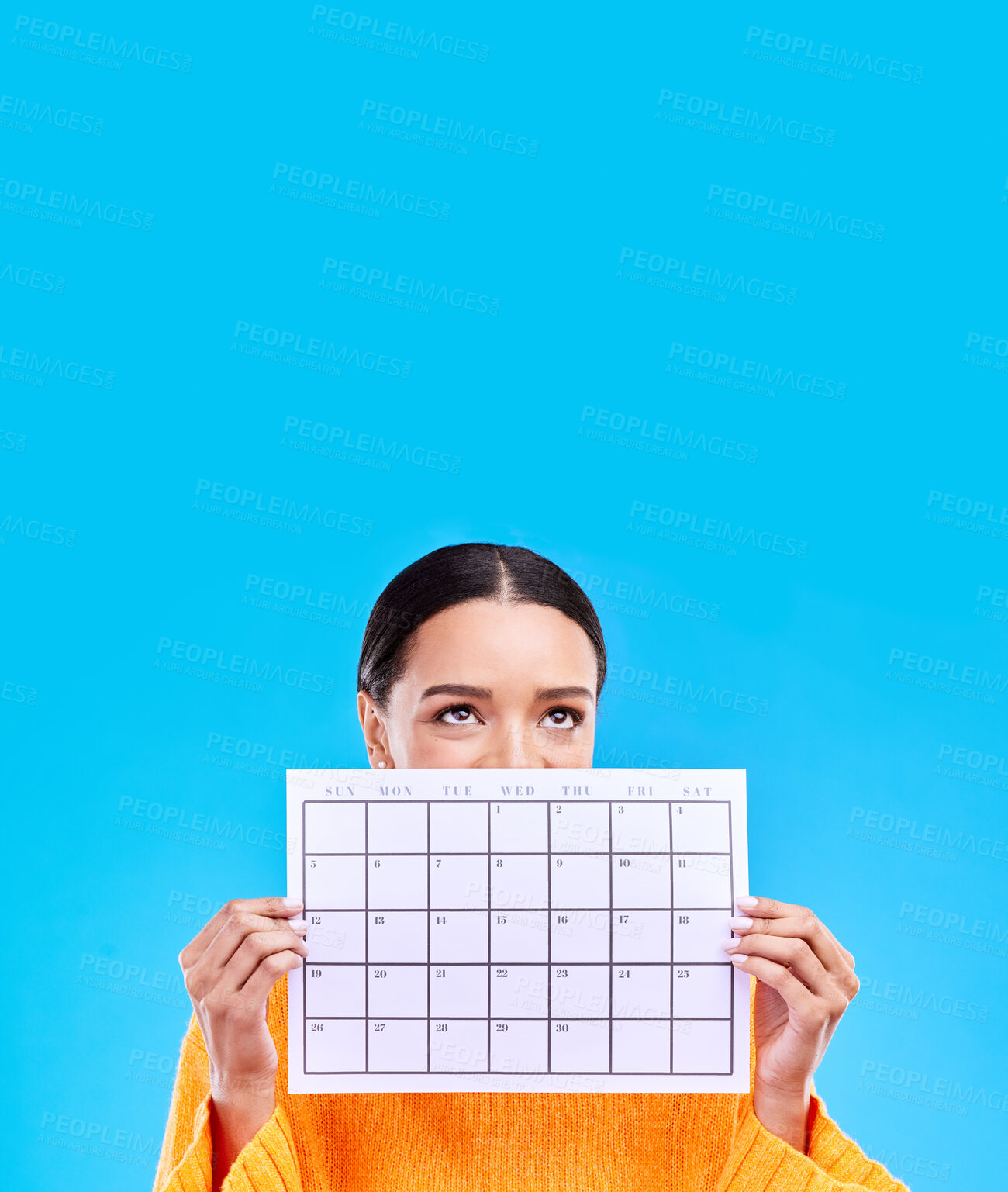 Buy stock photo Calendar, thinking and woman on blue background with paper for schedule, planning and agenda in studio. Time management, strategy and eyes of girl with month poster for date, weekly planner and event