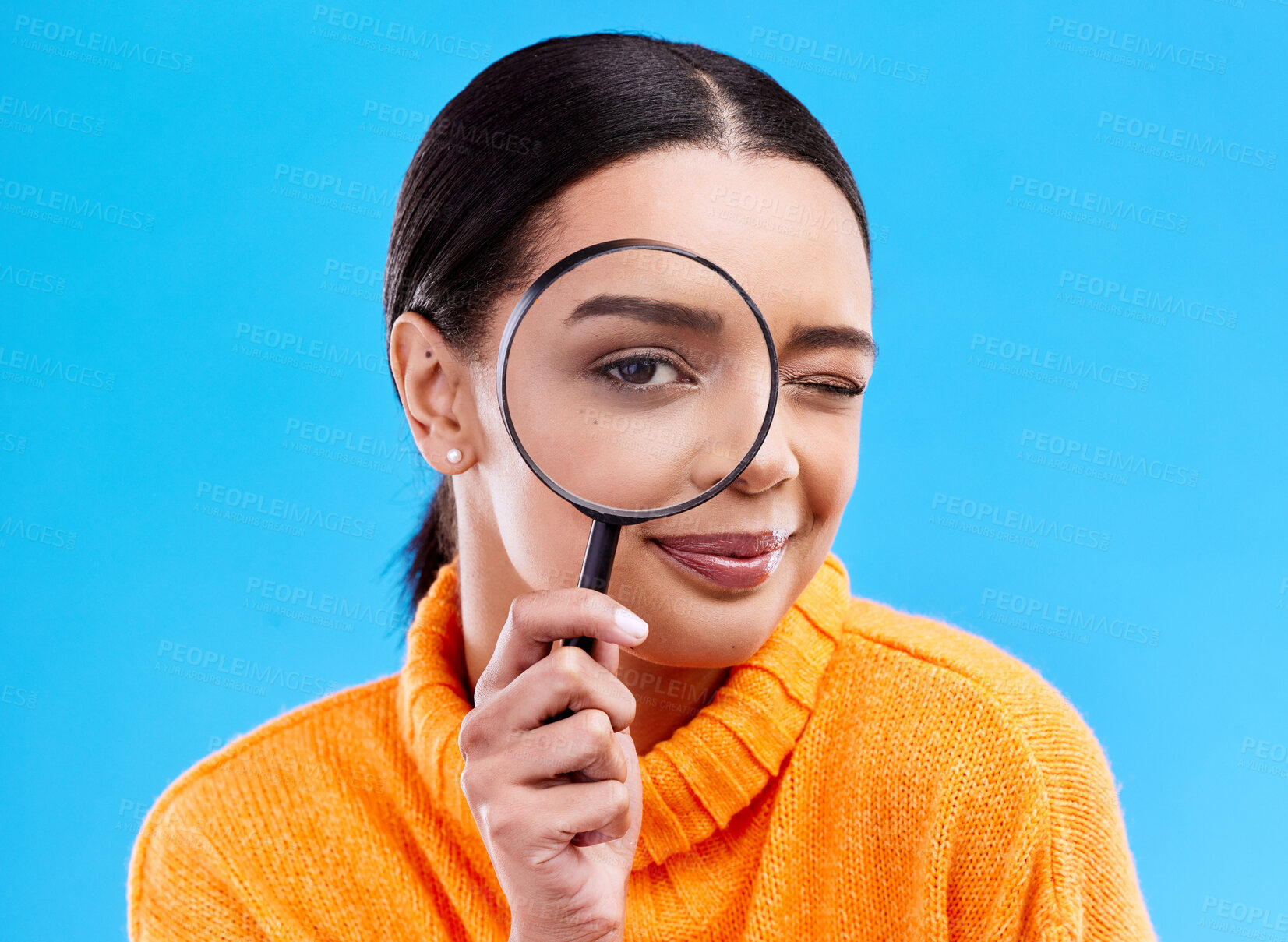 Buy stock photo Search, portrait and female with a magnifying glass in a studio for an investigation or detective cosplay. Happy, smile and headshot of a woman model with a zoom magnifier isolated by blue background