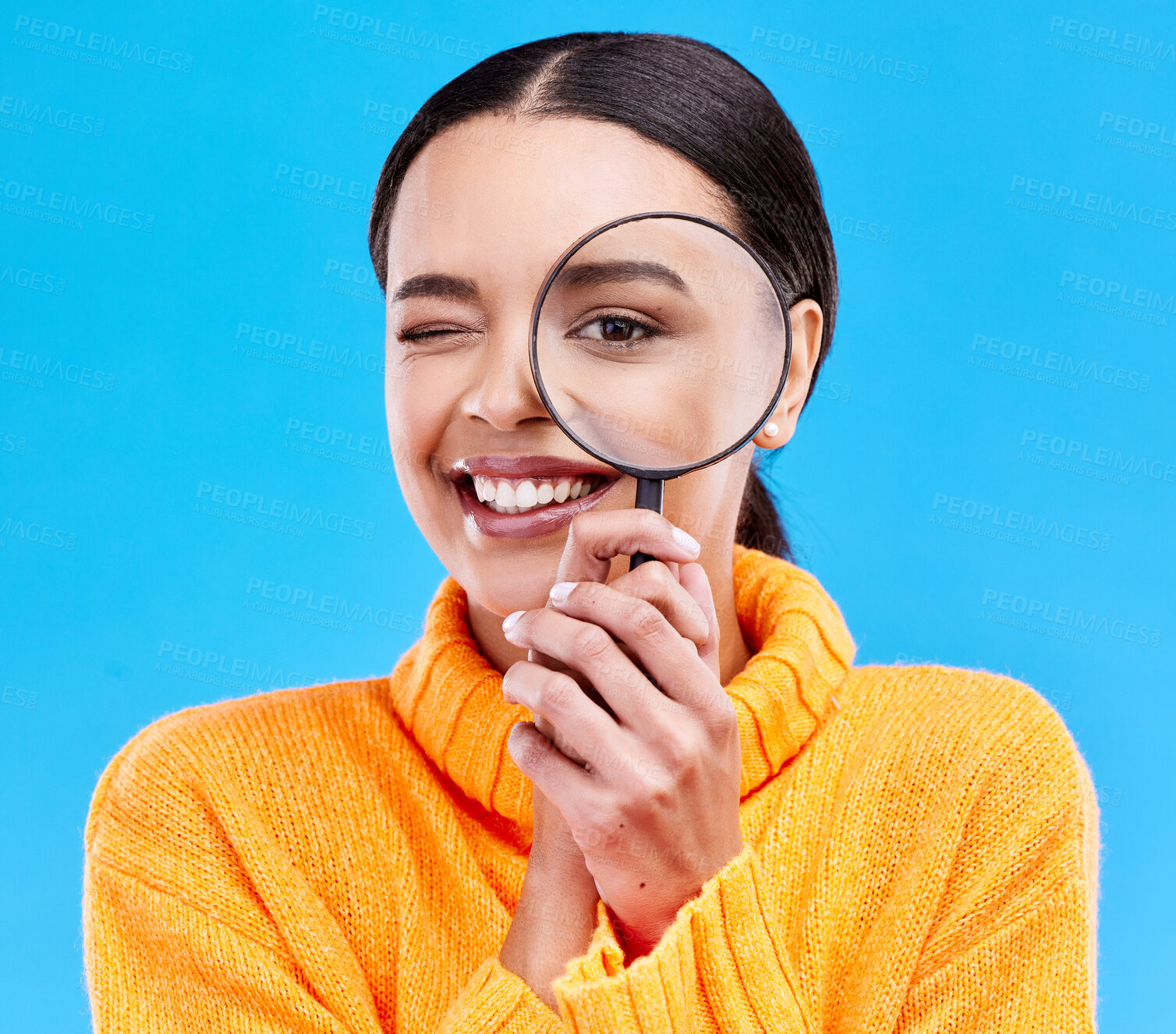 Buy stock photo Happy, portrait and woman with a magnifier in a studio for an investigation or detective cosplay. Happiness, smile and headshot of a female model with a magnifying glass isolated by a blue background