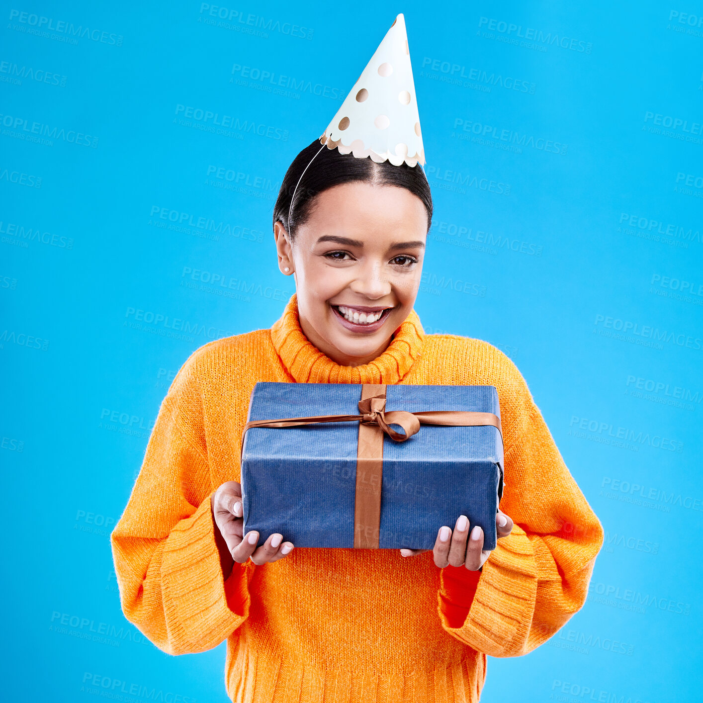 Buy stock photo Woman, portrait smile and gift in studio for birthday present, event or celebration against a blue background. Happy female smiling and holding gifts or box for party, surprise or giving on mockup