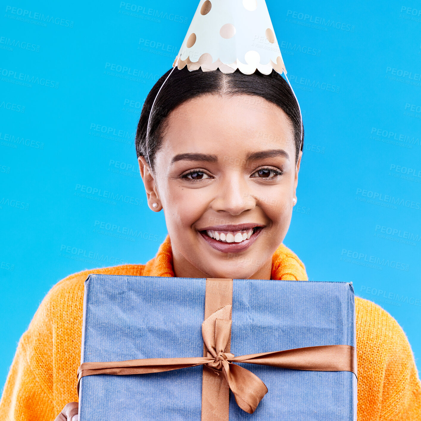 Buy stock photo Woman, birthday and box in studio portrait with smile, happiness and present by blue background. Girl, model and party with gift, hat and excited face for celebration, event and package by backdrop